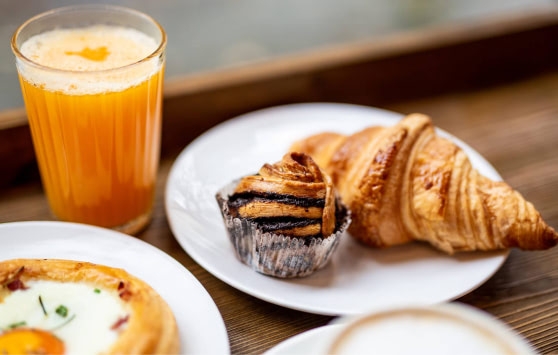 Continental breakfast with croissant and orange juice.