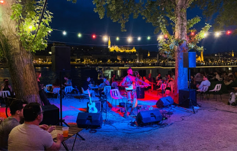 Band playing in open air at night.